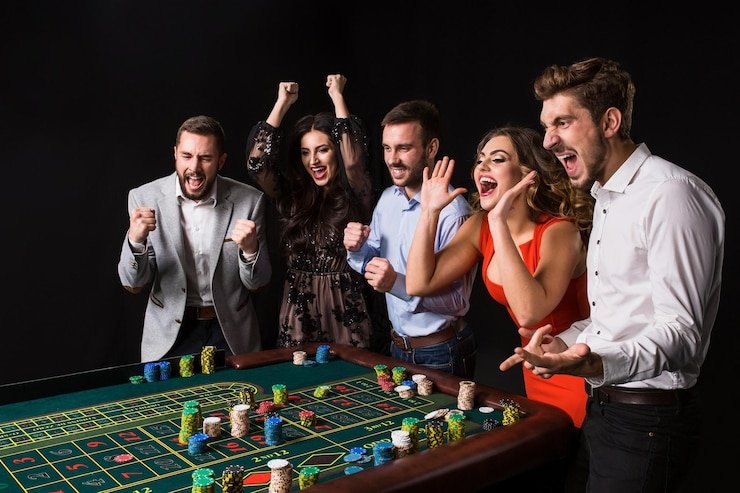 Multiple live casino table operators working in broadcast studio